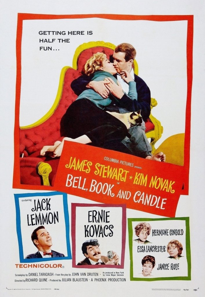 The movie poster for Bell, Book and Candle offers the tagline "Getting here is half the fun". The top half of the poster features Jimmy Stewart and Kim Novak, barefoot on a chaise longue, embracing, with a Siamese cat sitting atop them both. The bottom half is divided into multiple boxes announcing the supporting cast: Jack Lemmon, Ernie Kovacs, Hermione Gingold, Elsa Lanchester, and Janice Rule.