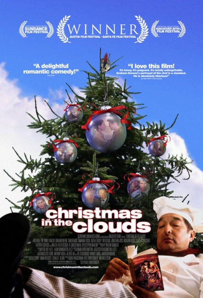 The poster for "Christmas in the Clouds" depicts a Christmas tree covered in large bauble ornaments, each of which displays one or two actors from one of the movie's many subplots. In the foreground, Graham Greene as Earl the chef has his feet up as he leans back to read a Native American romance novel.