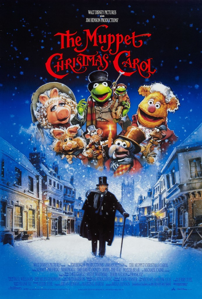 The poster for The Muppet Christmas Carol depicts Ebenezer Scrooge in a top hat with a cane, walking towards us down the middle of an empty snowy street, while above him in the snowy sky we can see multiple members of the Muppet cast, including Gonzo, Kermit, Fozzie, and Miss Piggy, smiling and looking in our direction.
