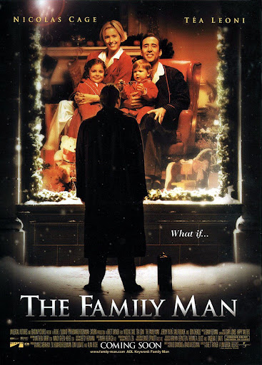 The poster for The Family Man depicts Nicolas Cage from behind as he stands in a trenchcoat on a snowy street with his briefcase on the sidewalk beside him. He is looking in through a large picture window at an image of himself seated in an armchair with Tea Leoni and their kids, cuddling together to post for a family Christmas photograph.  The tagline appearing next to him reads, "What if..."
